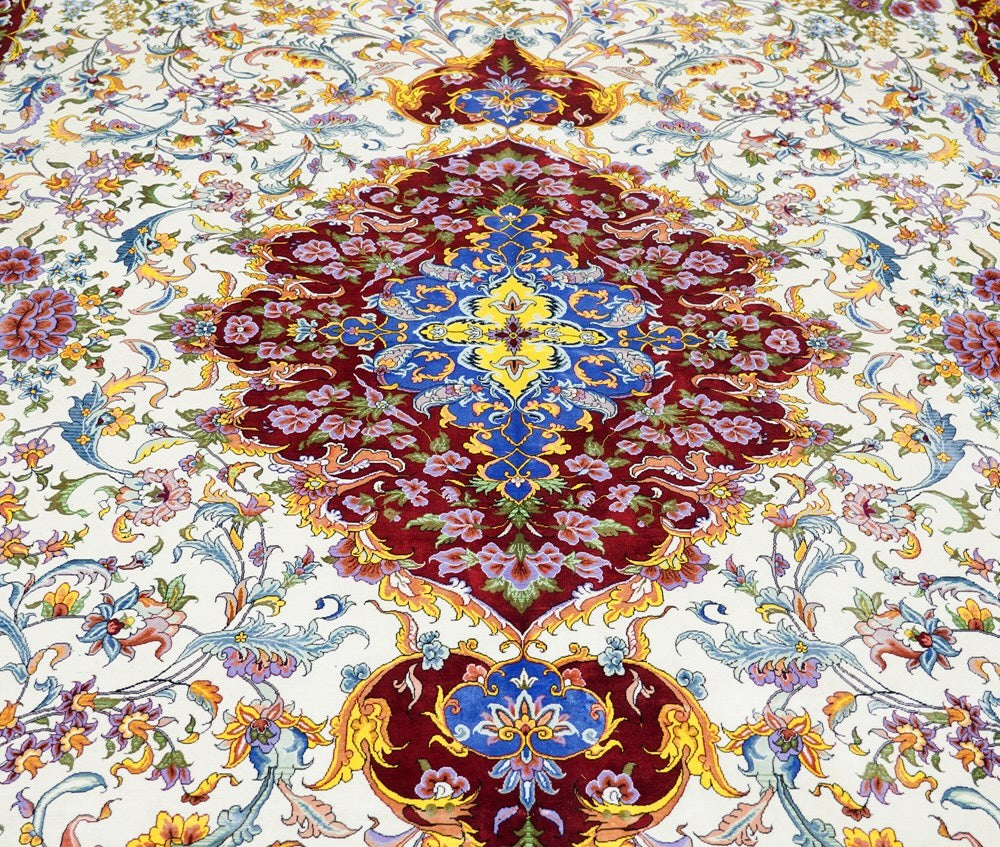 A beautiful handknotted silk carpet with intricate flower designs
